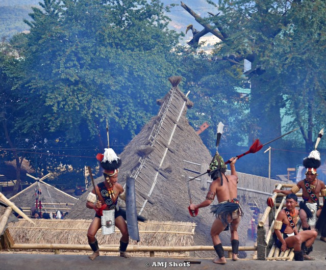 DSC_2127 Khiamniungan warriors showing a fight scene above the log drum.
