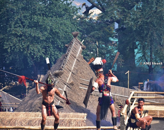 DSC_2132 Khiamniungan warriors showing a fight scene above the log drum.