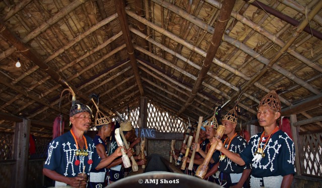 DSC_2387 Chang stribe playing their Log Drum using broad headed wooden short blocks.